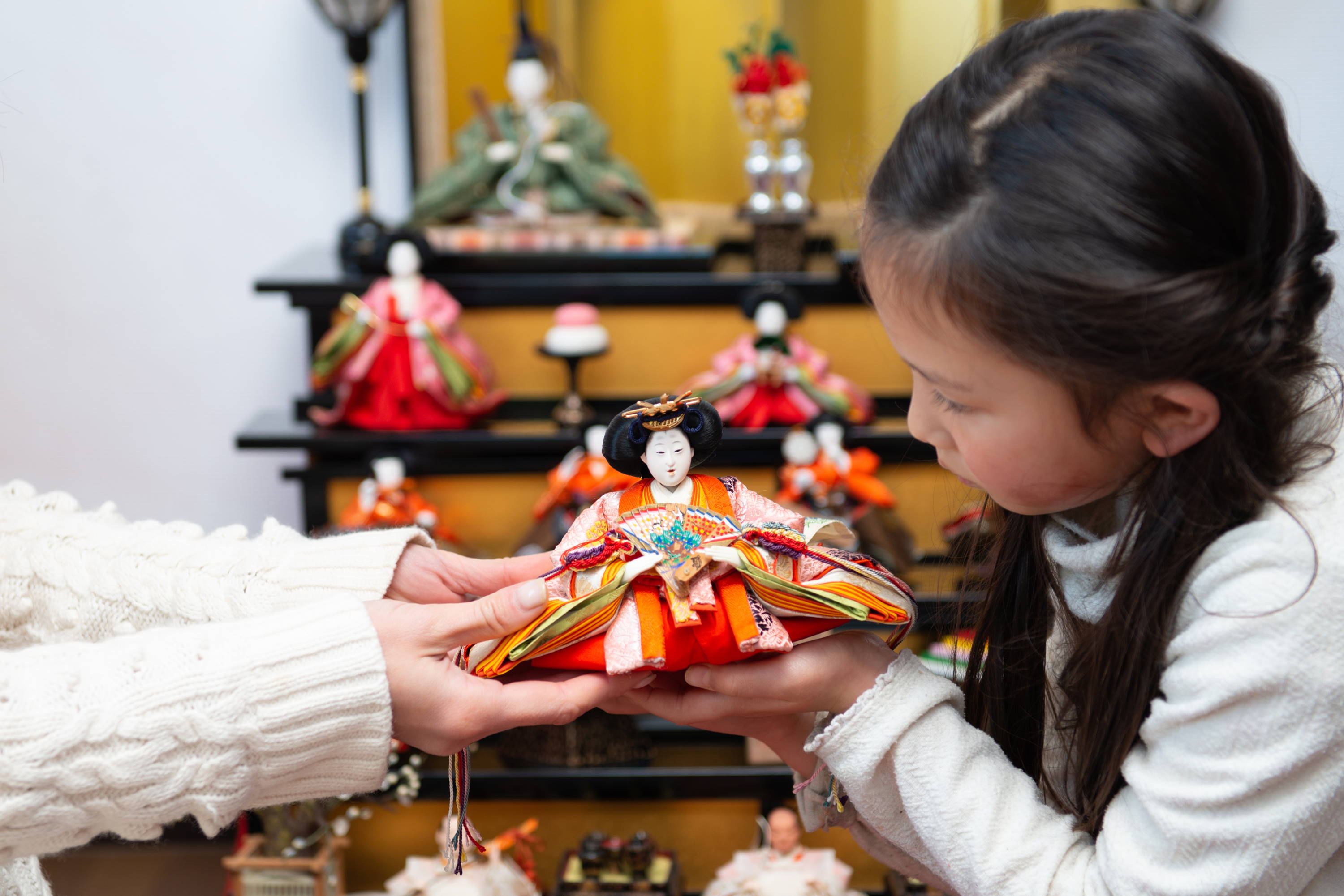 mother and daughter setting up hinamatsuri display