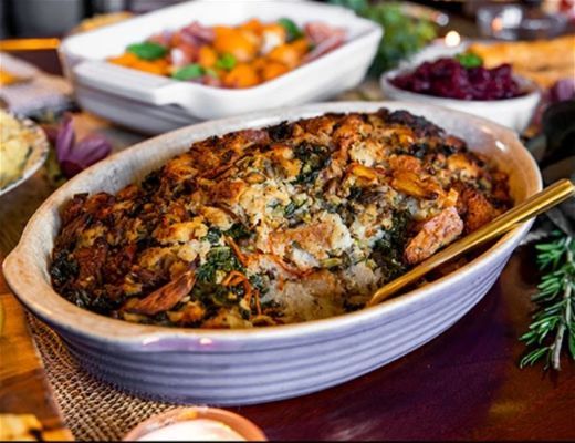 Baked dish with a golden crust and herbs, served on a festive table.