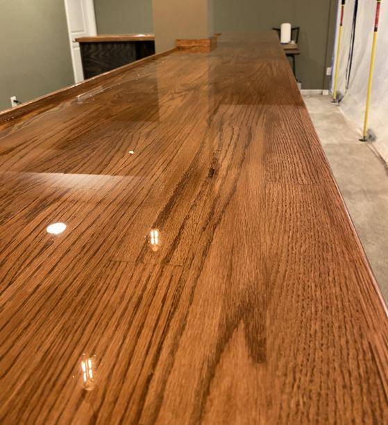 A close-up of the wooden corner epoxy bar top with a coating of UltraClear Epoxy.