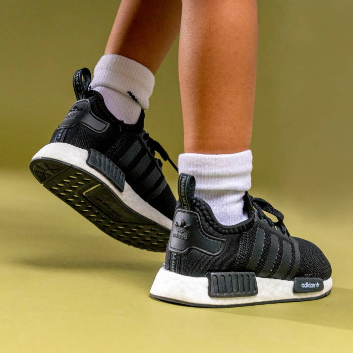 black adidas ultraboost on child's feet