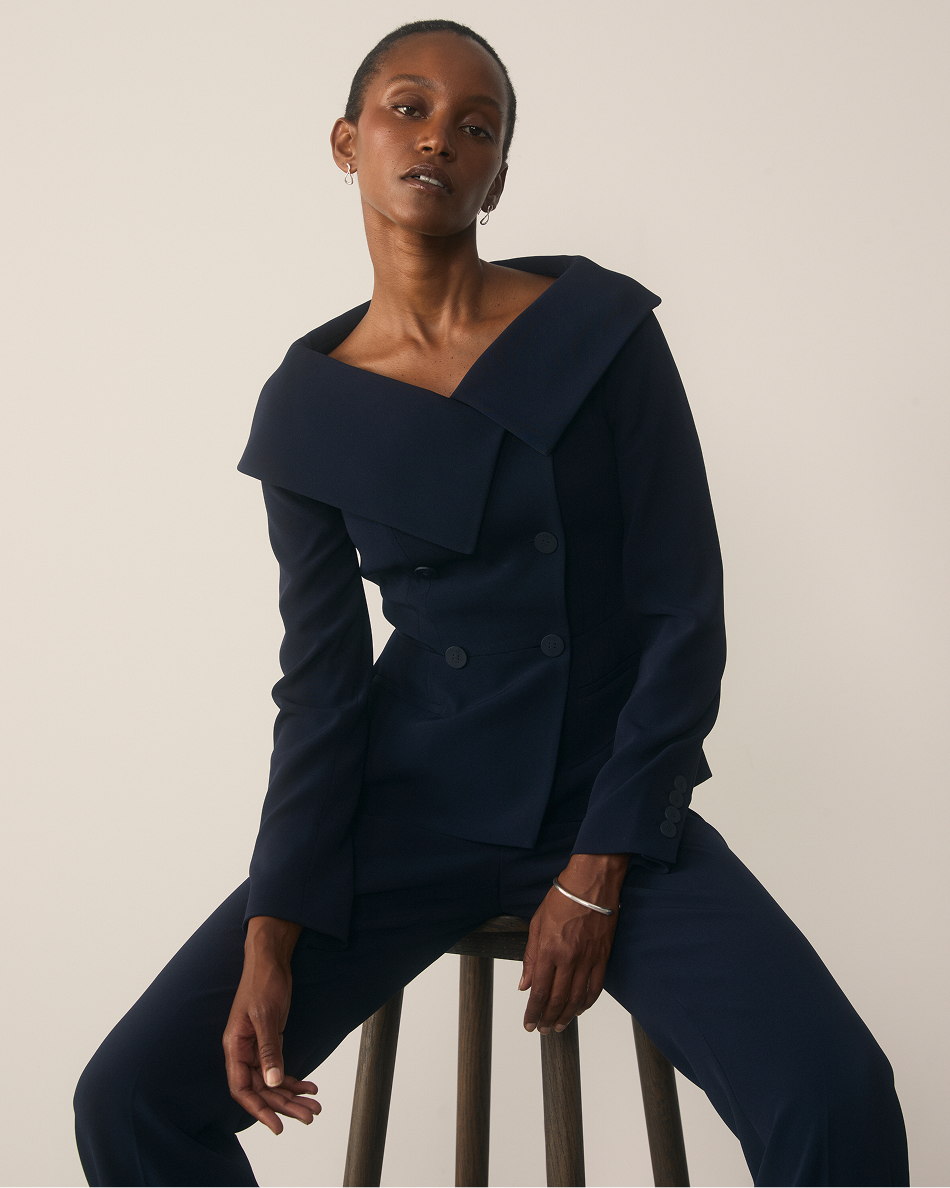 Model wearing navy Lorelli jacket and Clever Crepe trousers