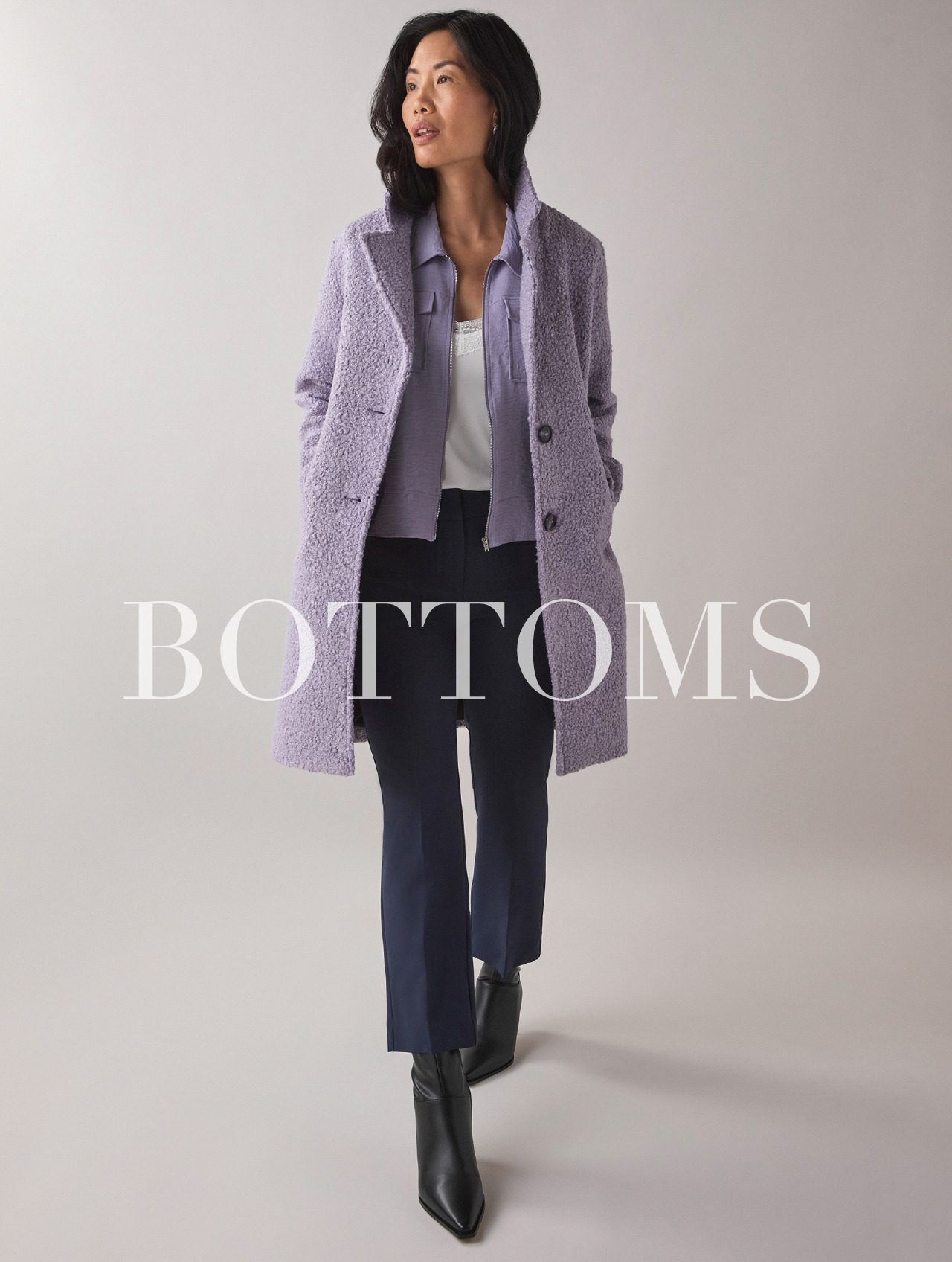 Model wearing a purple coat and dark pants, with the word 