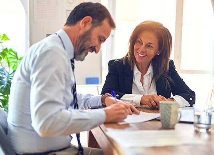 man-and-woman-signing-a-contract