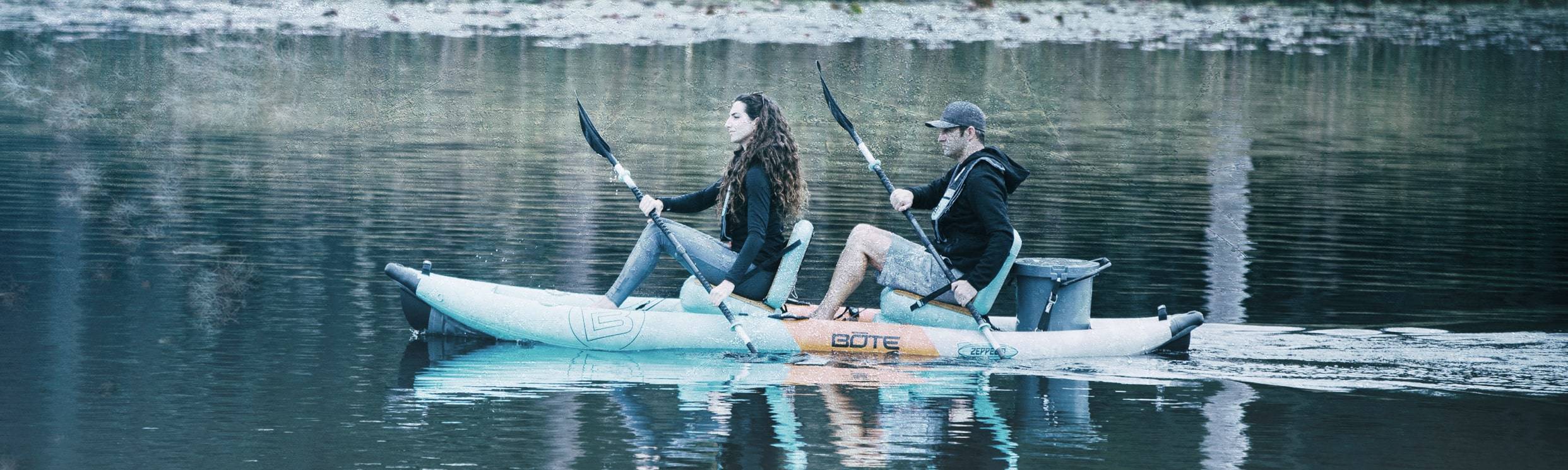 Two people paddling a Zeppelin Aero 12′6″ Native Aqua Inflatable Kayak.