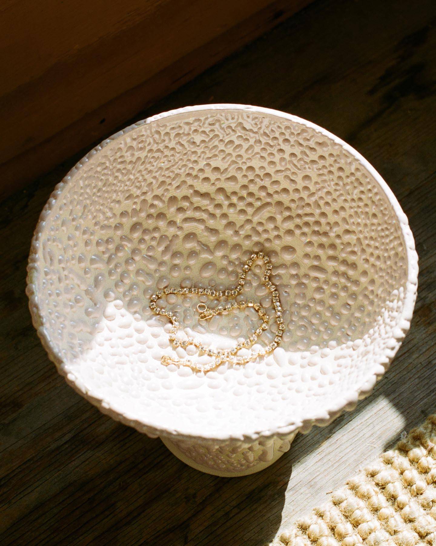 Mondo Mondo necklace resting in a Raina Lee ceramic dish.