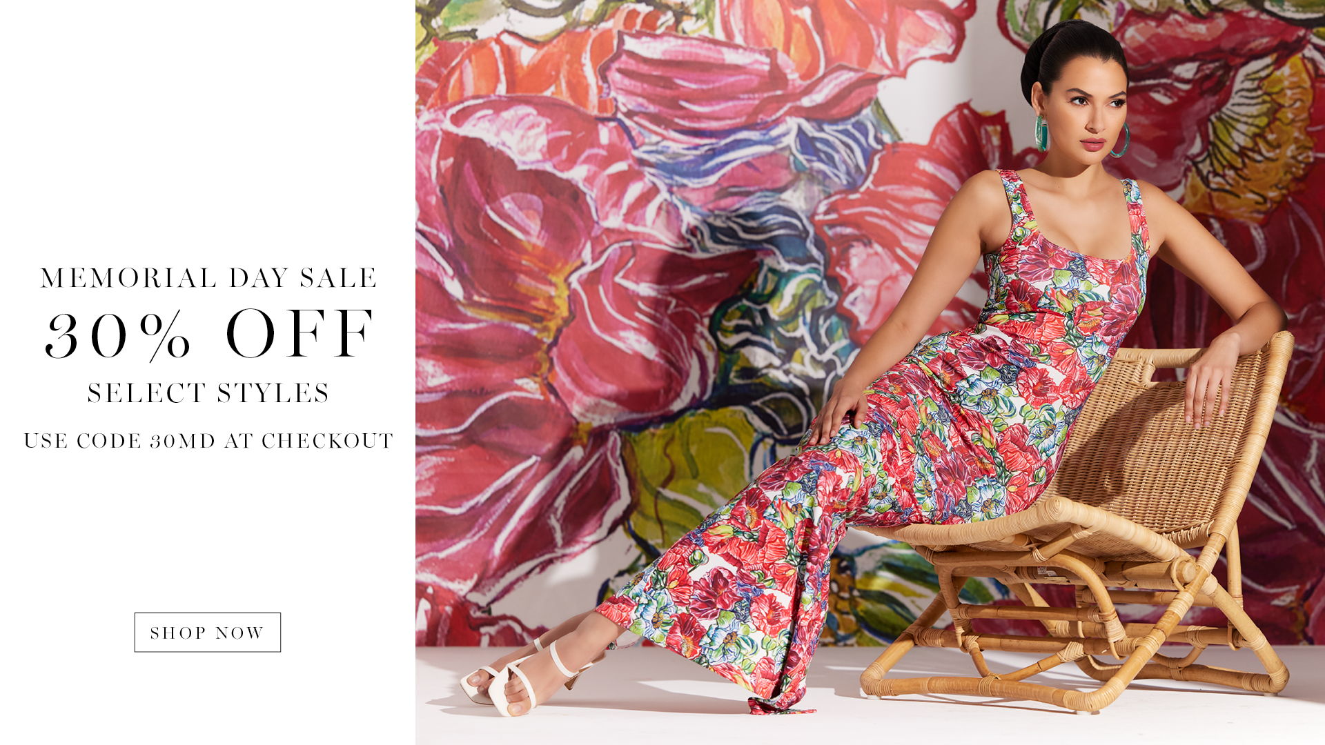 Woman in floral dress sitting on a chair against a colorful background.
