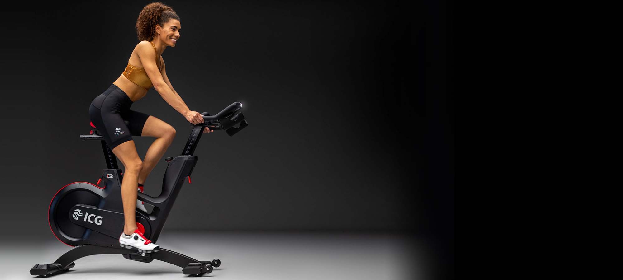 Female riding IC7 Indoor Cycle
