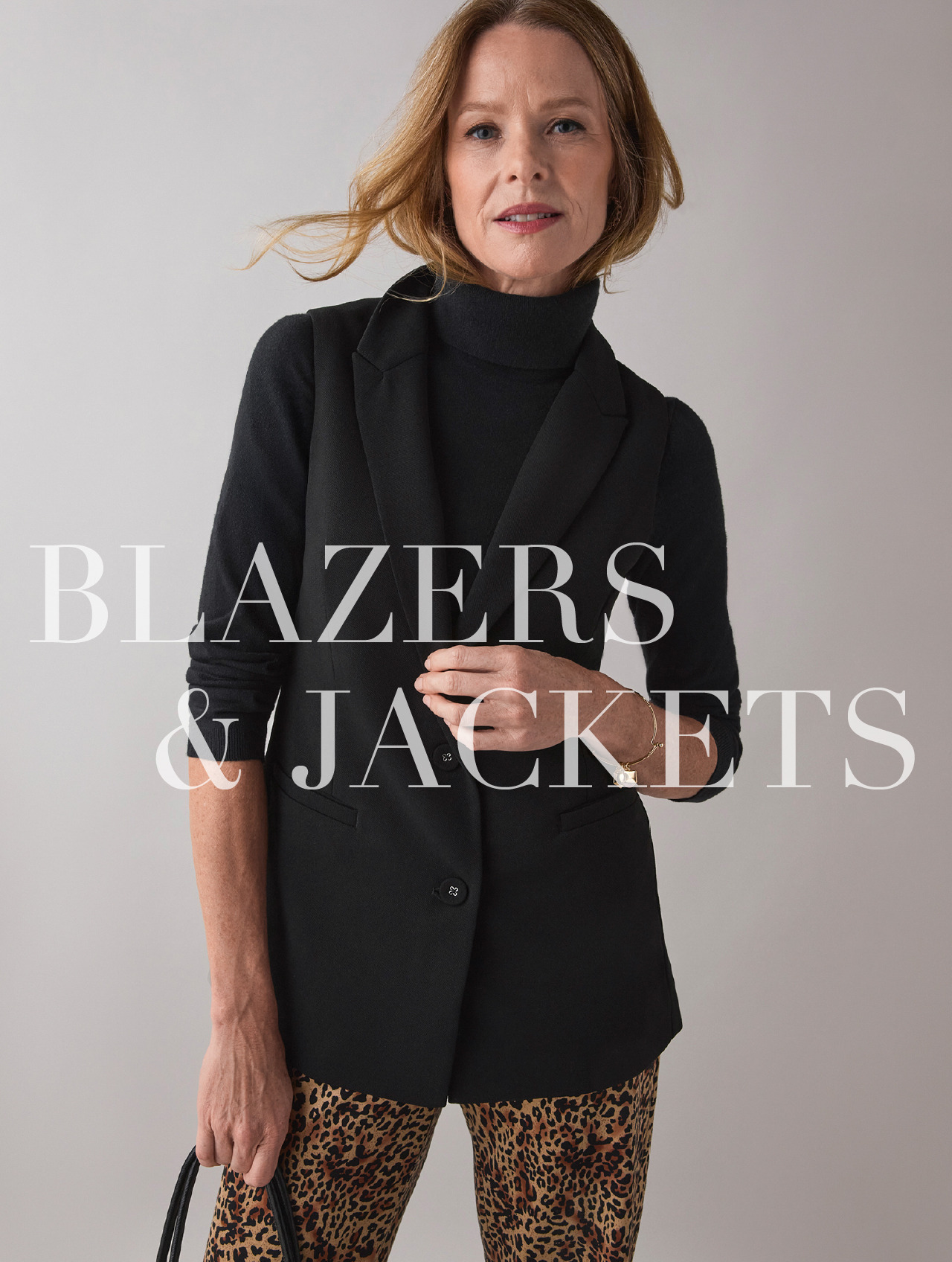 Woman in a black blazer with text 