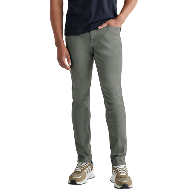 Man wearing olive green pants and sneakers, standing casually.