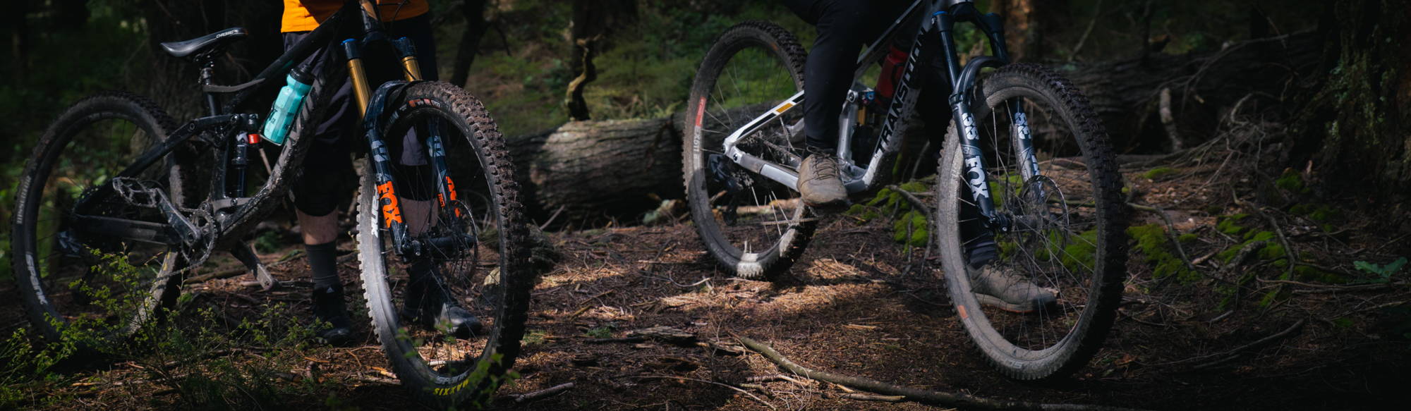 Fox float 38 factory series on a devinci spartan and a fox float 38 performance series elite on a transition spire in the woods