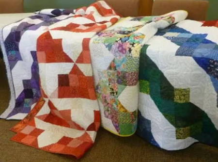 Four colorful Quilts Made by Carole Carter