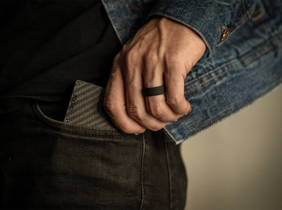man pulling a wallet with a Gunmetal 8MM Beveled Ring on his finger