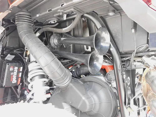 Engine bay dual silver air horn trumpets NOCO genius charger black intake hose coilover KJ Motorsports Conductor's Special 244 Nightmare Edition gallery photo 4