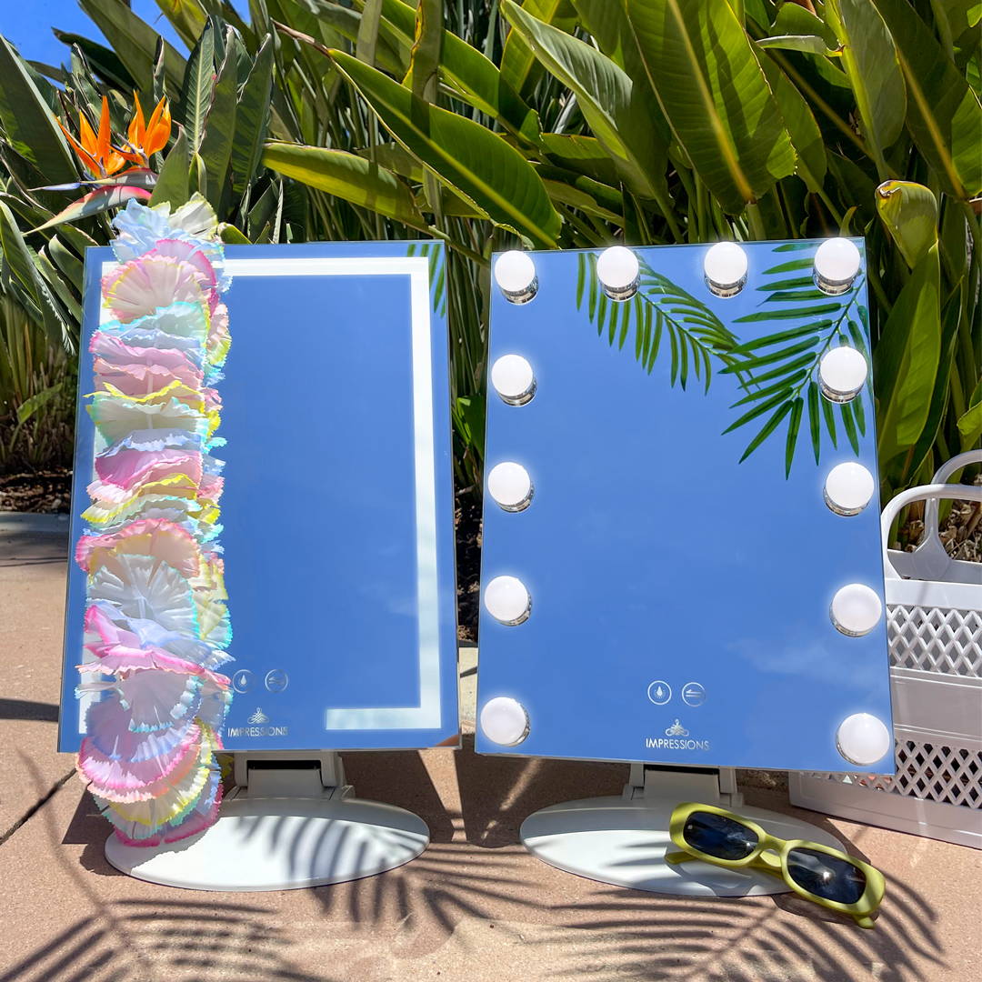 Two display models of lumiere mirror with hawaiian lei.