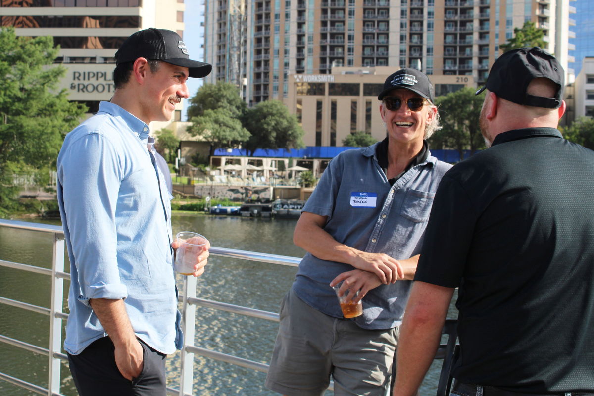 Three men having a conversation on a boat