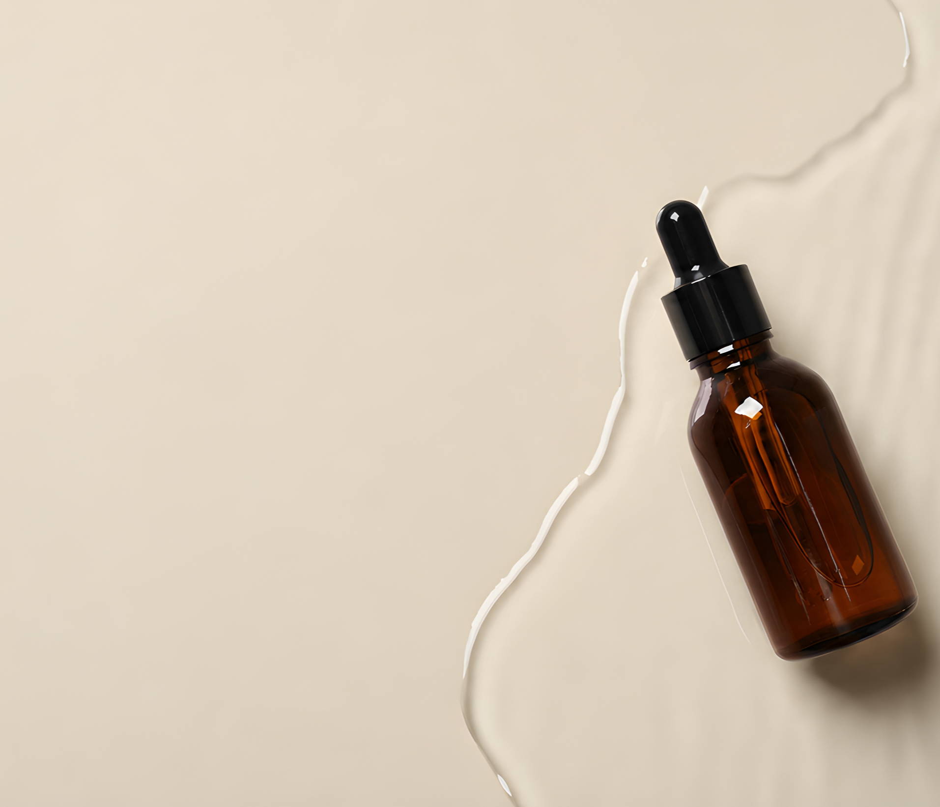 Brown glass dropper bottle on a light textured surface.