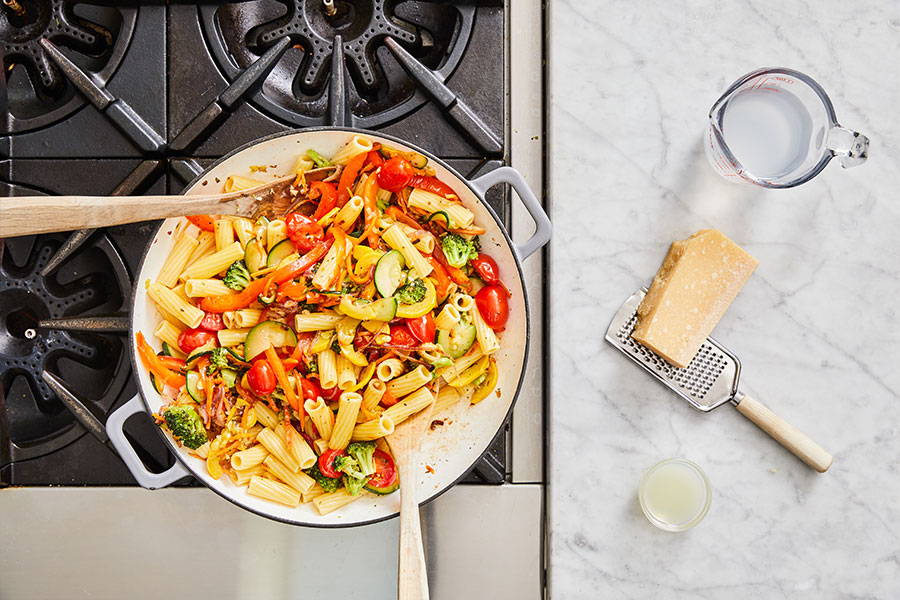 Pasta and vegetables stirred to combine.