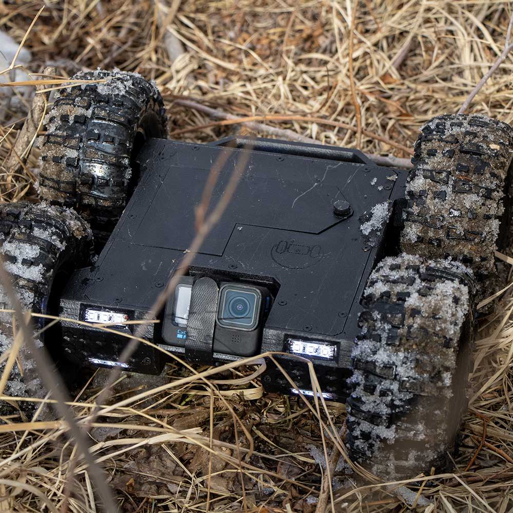 home inspection robot mink crawling through grass and mud