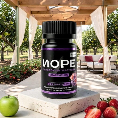 Black supplement bottle on a stone table with fruits and greenery in background.