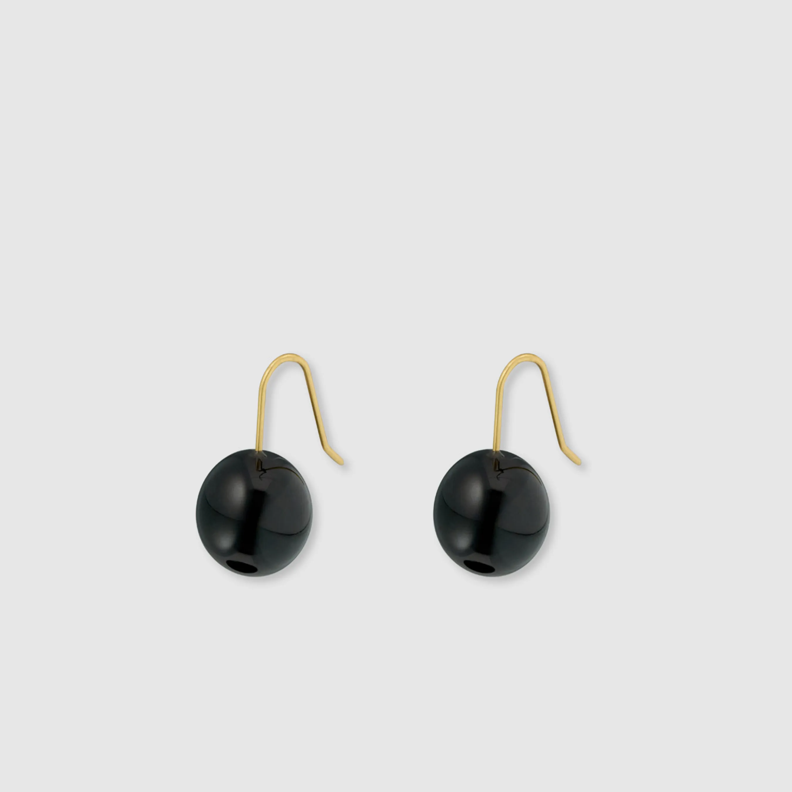 Black round earrings with gold hooks.