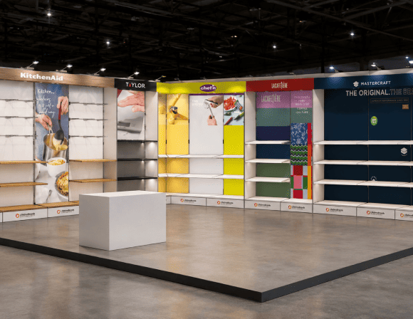 Modern exhibition space with colorful walls and a central display stand.