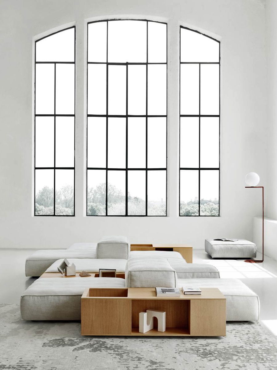 Modern living room with large windows and minimalist Living Divani furniture.