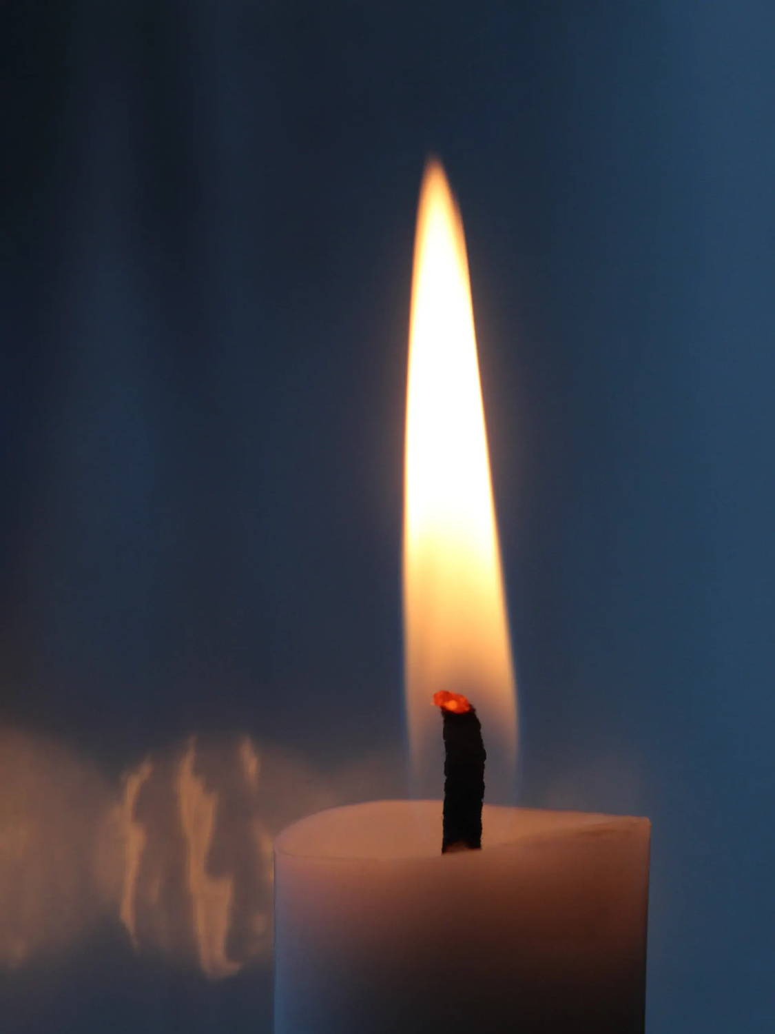Closeup of a lit taper candle