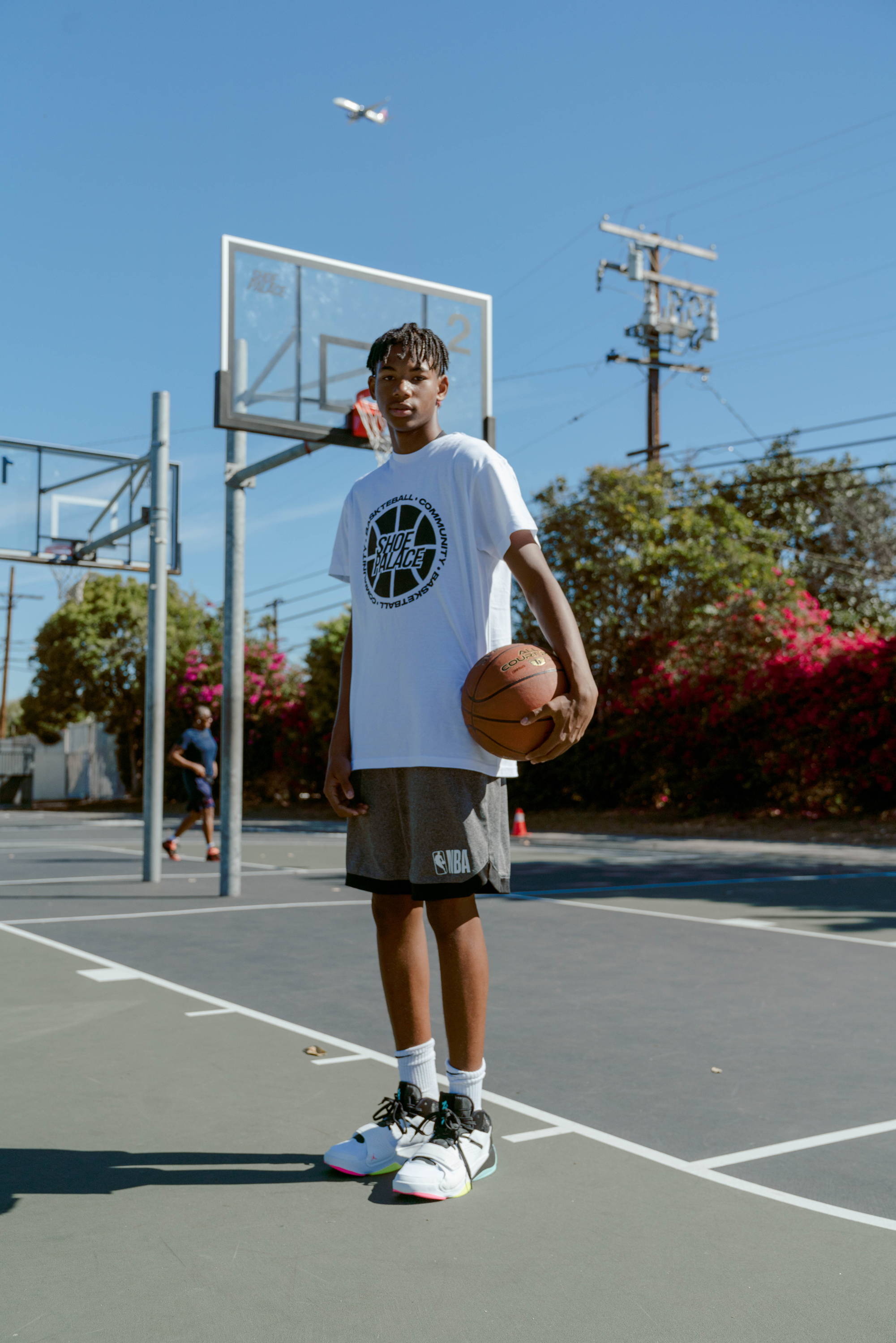 darby park hoop clinic boy stands under basketball hoop