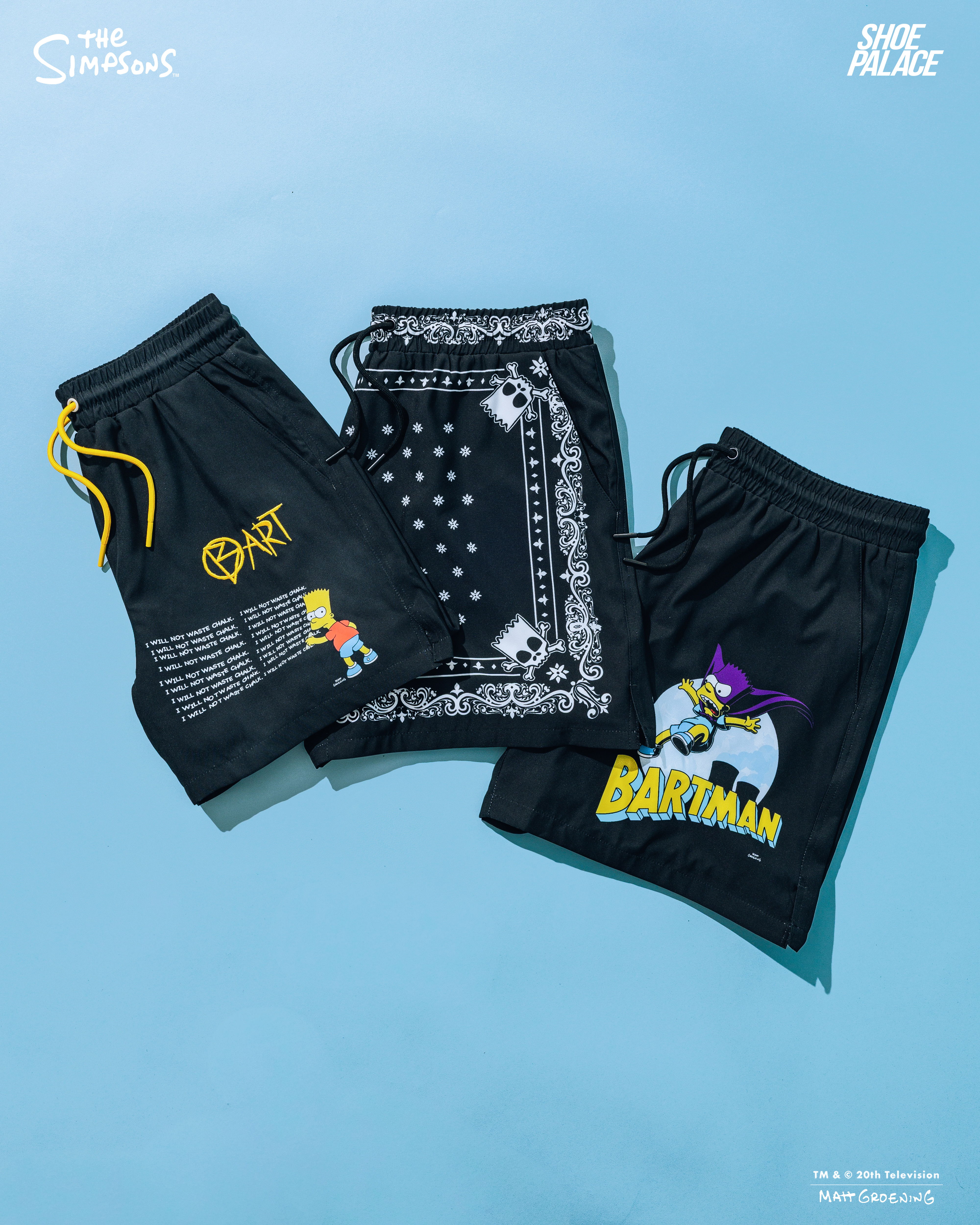 Three pairs of black shorts with graphic designs on a blue background.