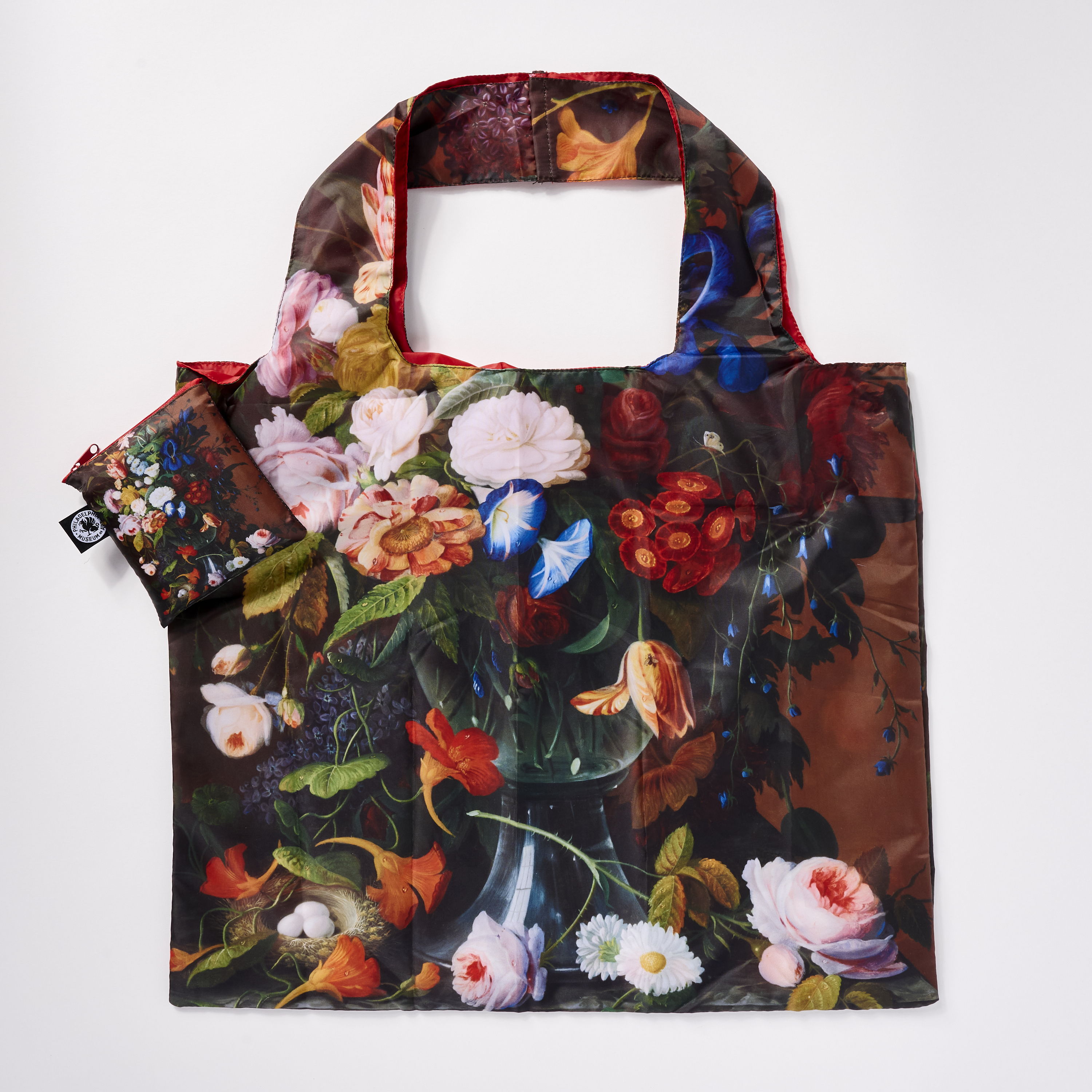 A floral-patterned reusable shopping bag with a matching pouch.