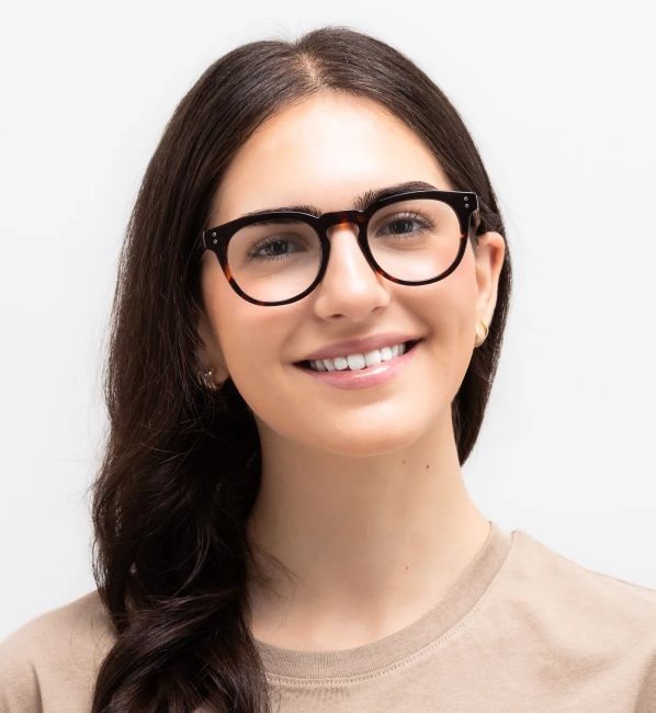 woman wearing Noa, rounded square tortoise eyeglasses for oblong face shapes, on a white background