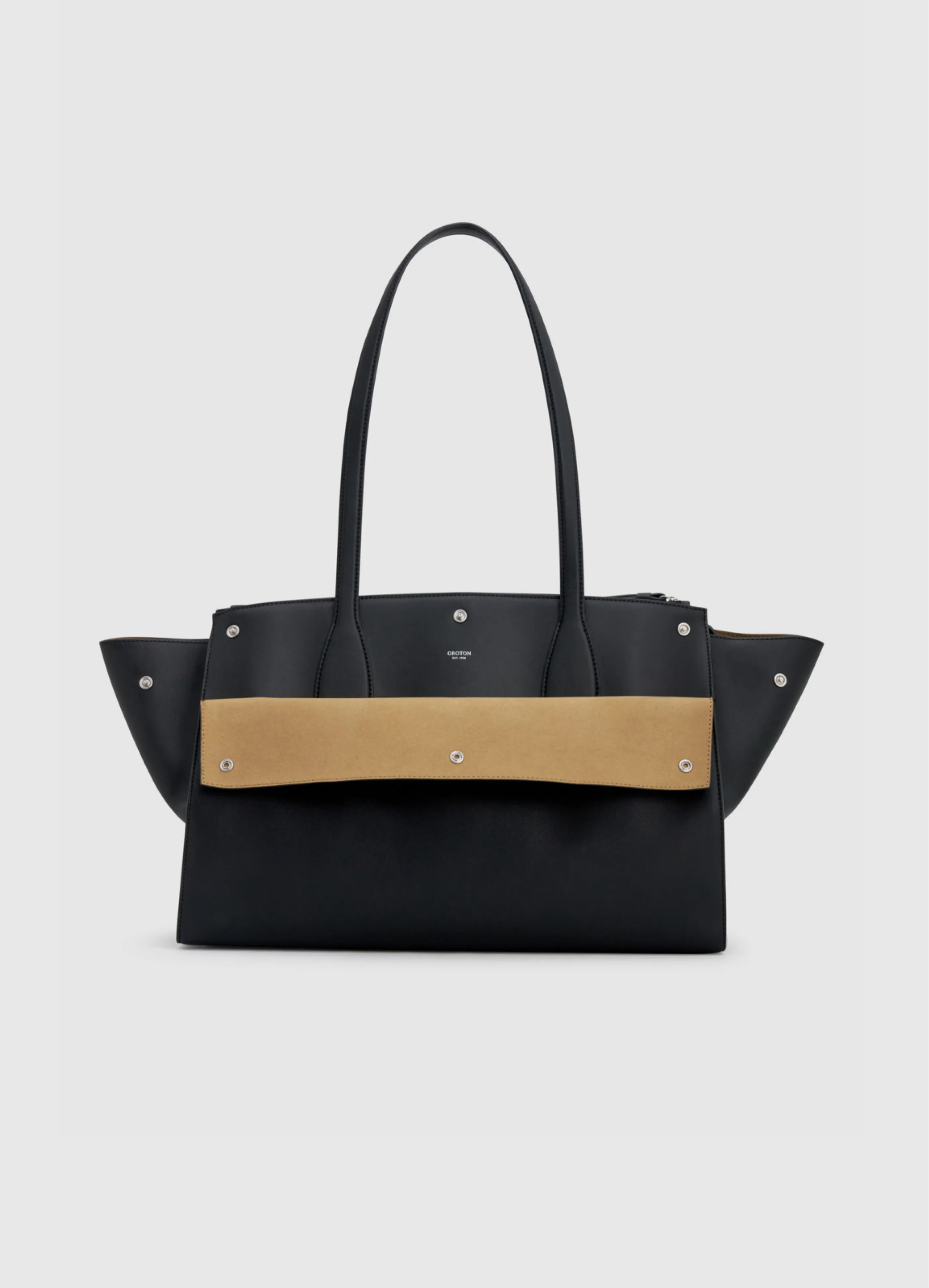A black handbag with a tan strap and decorative studs.