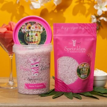 Two containers of pink sprinkles on a wooden surface with yellow background.