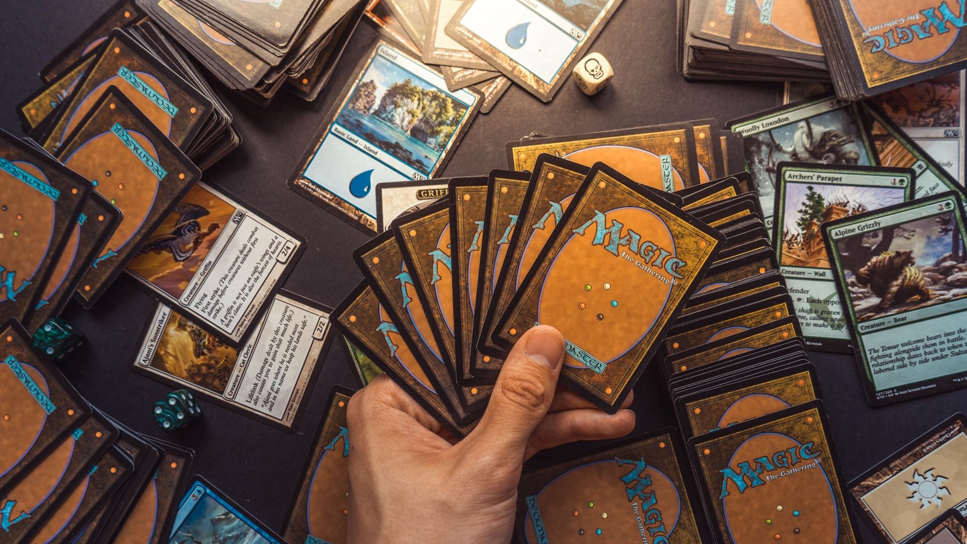 mtg commander tips - Toxic Commander Habits That Ruin MTG Game Night Hand holding Magic: The Gathering cards with lands and creatures.