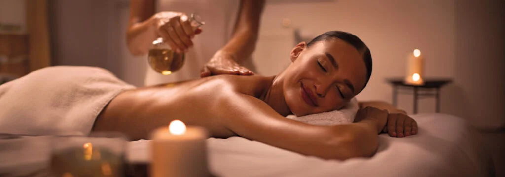 Person receiving a massage with warm oils in a relaxing setting.