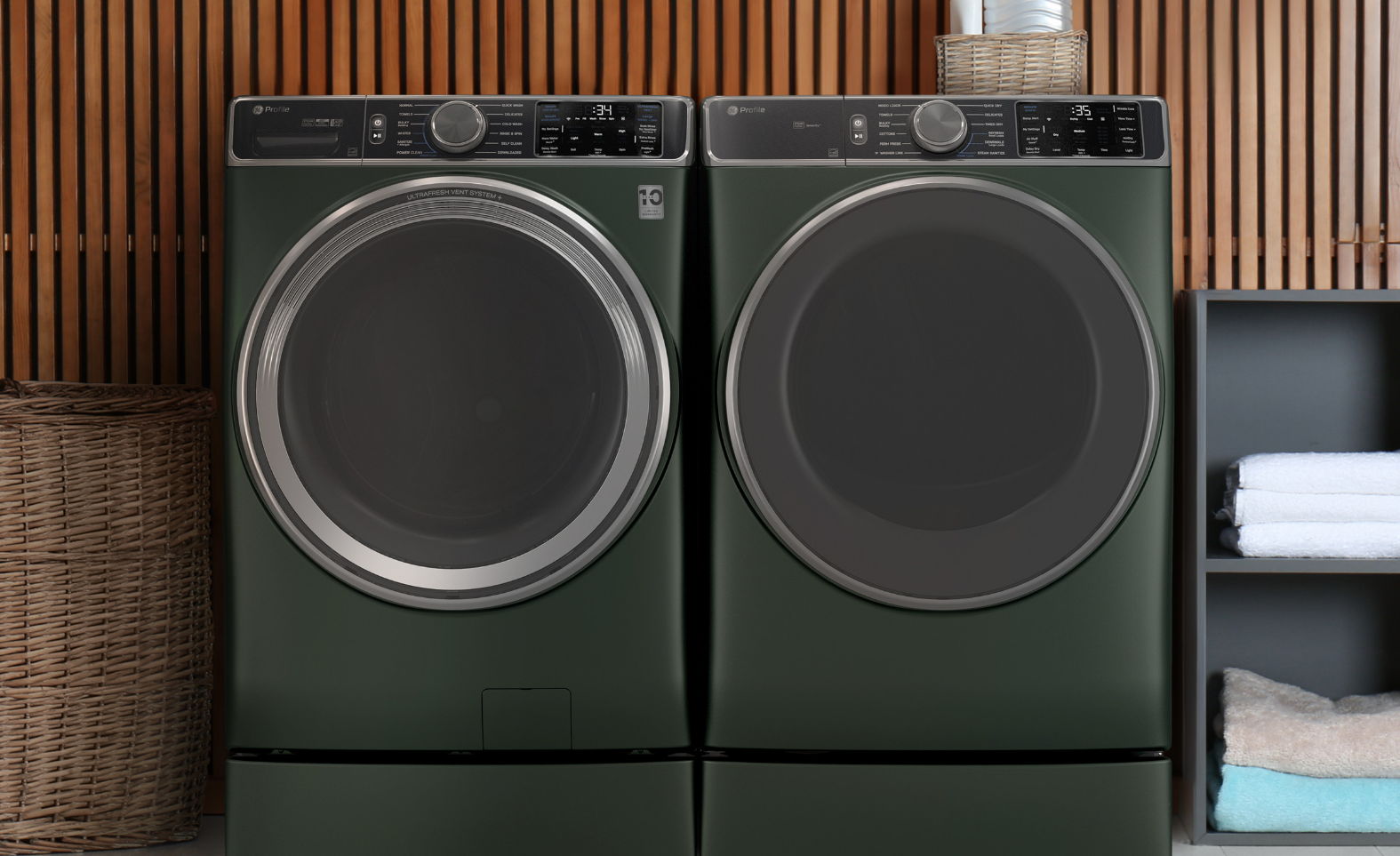 Two green washing machines side by side in a modern laundry room.