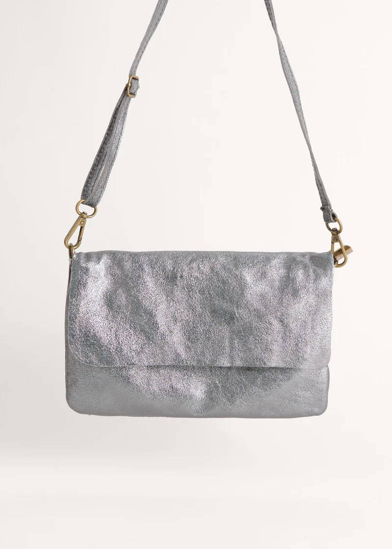 A metallic silver clutch bag with detachable shoulder strap