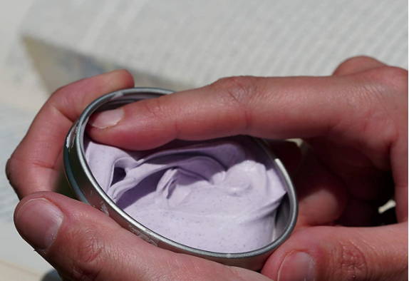 Scented putty, finger touching purple putty, sensory fidget