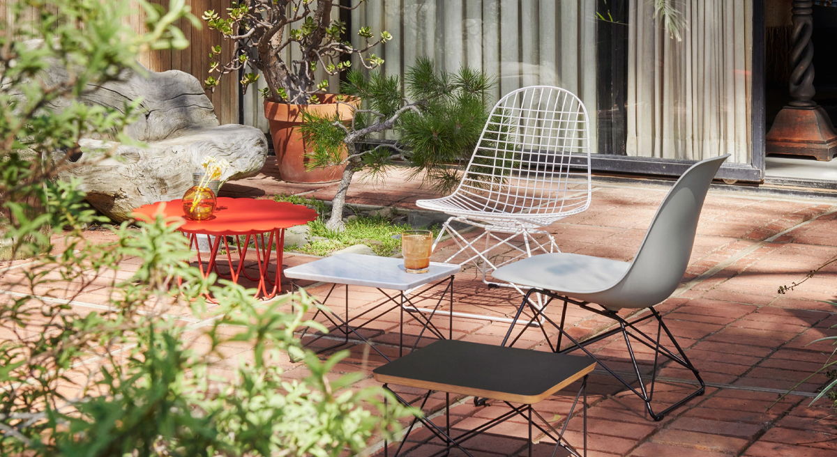 Outdoor seating area with various chairs and small tables.