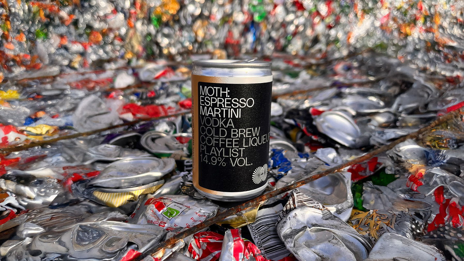 A can on a pile of crushed aluminum cans.