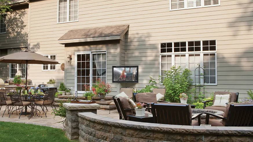 Outdoor living area firepit, dining table, and The TV Shield outdoor TV