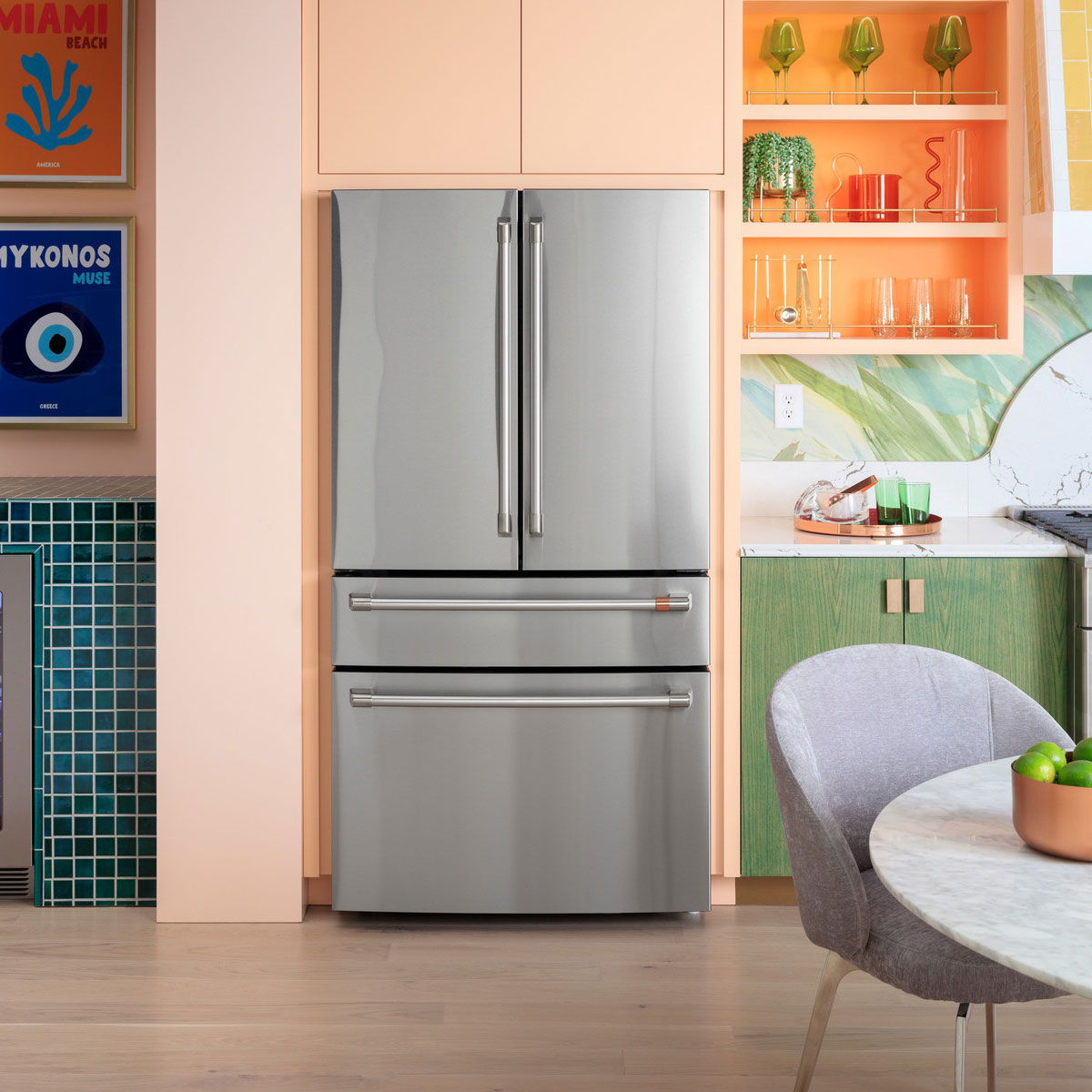 Café stainless steel refrigerator in a colorful kitchen setting.
