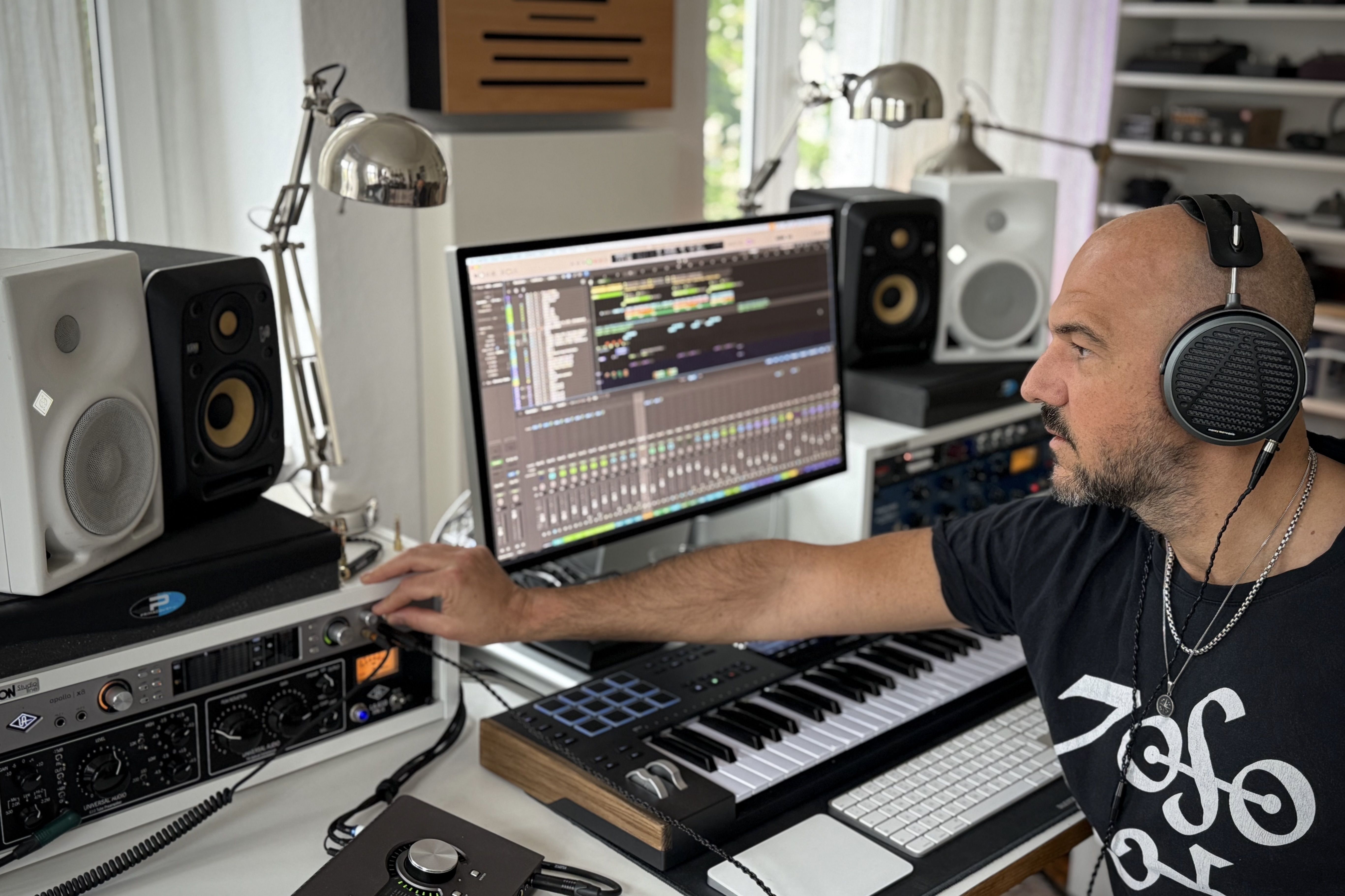 Stefan Bühler wearing Audeze MM-500 headphones mixing in the studio 