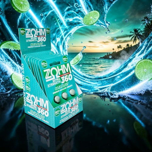 Box of ZOHM supplements with lime slices and a beach background.