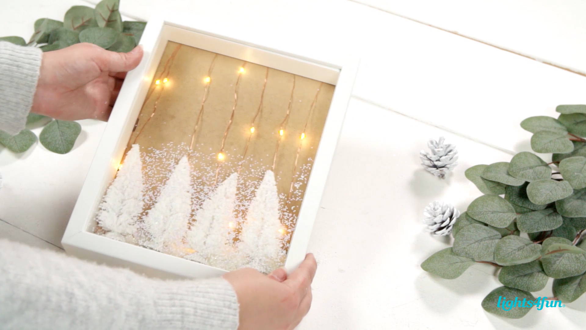 Scandi inspired Christmas woodland scene with mini white Christmas trees and fake snow. All  placed inside a shadow box.