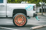 Rear side profile Nick's Silverado with XF Off-Road decal and teal train horns under bed photo 2
