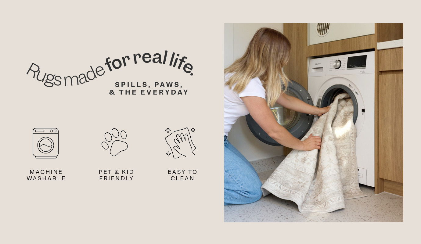 Person loading laundry into a washing machine in a home setting.