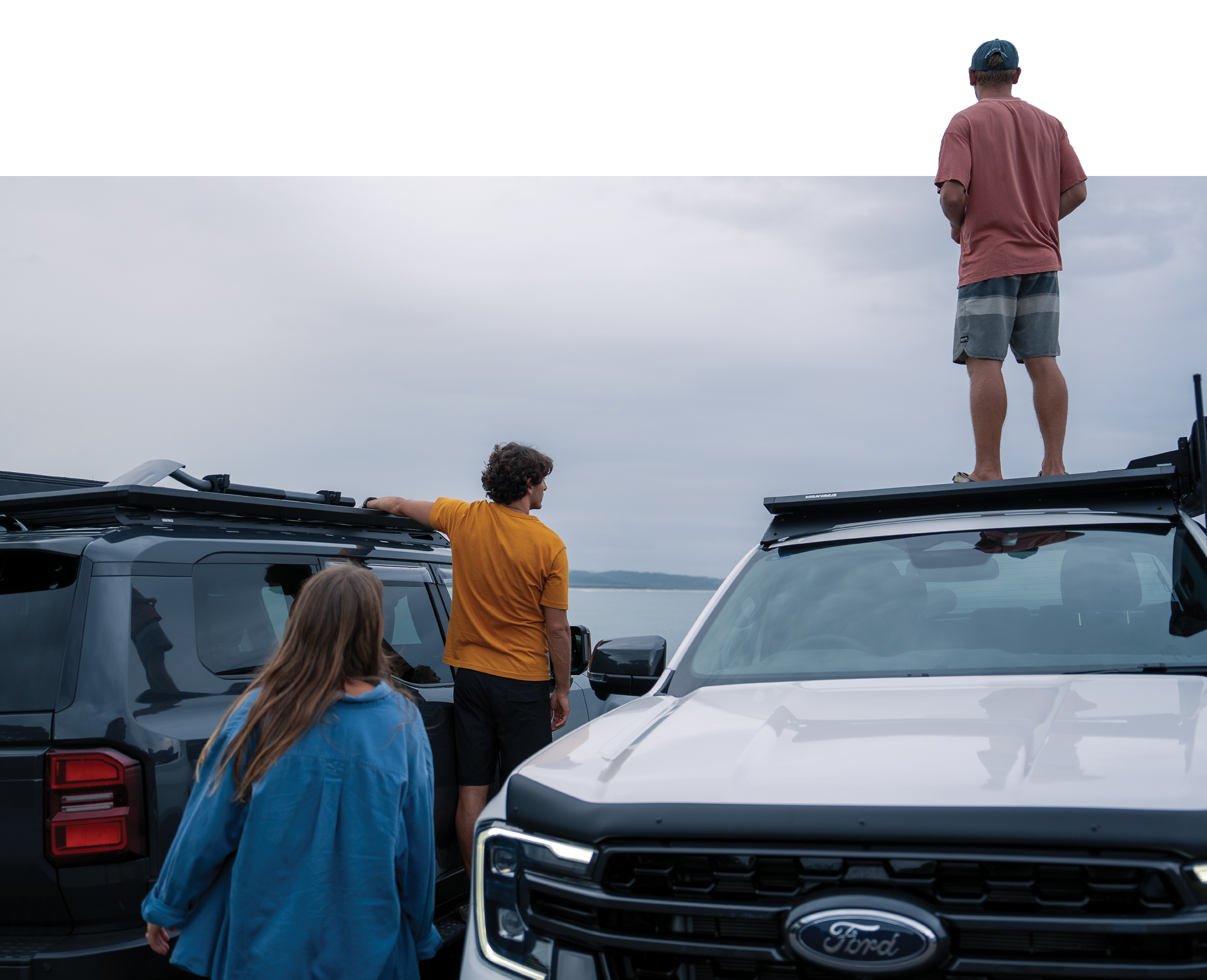 Two 4WDs with platforms and three people 