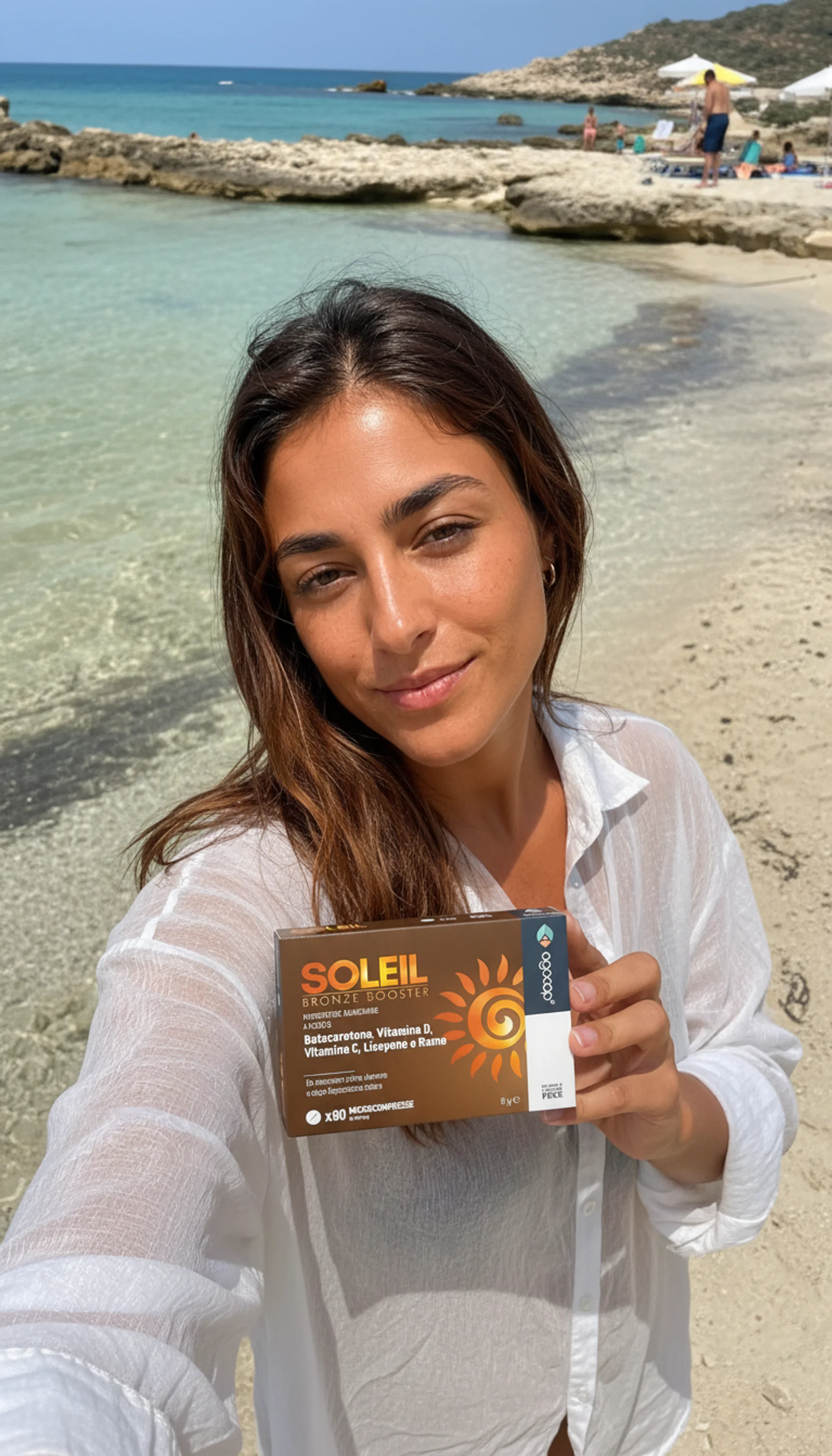Woman holding Soleil Bronze Booster at the beach