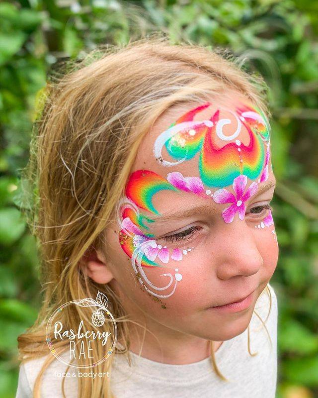 rainbow and flowers with swirls face paint girl